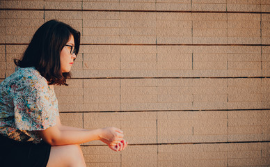 Asian woman sitting alone and depressed,stop abusing domestic violence, health anxiety.