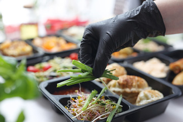 Meal prep containers, the chef prepares a meal in a boxed diet delivered to order.