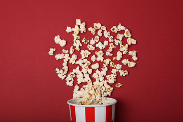 popcorn in a paper cup on a colored background