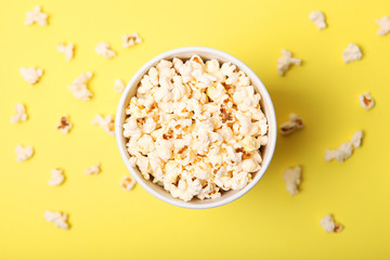 popcorn in a paper cup on a colored background