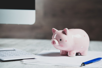 piggy bank with computer on the desk