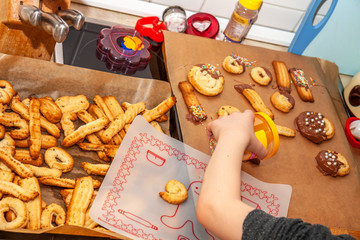 Little girl baking cookies in the kitchen at home
