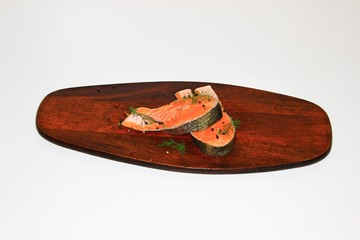 red fish on a dark chopping Board