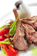 Grilled Lamb Rack with Baked Vegetables on White Restaurant Plate