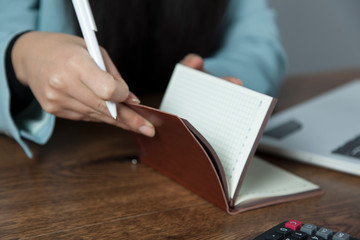 woman hand notepad with computer