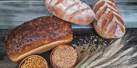 Various breads on wooden background.