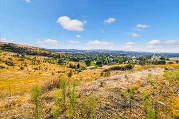 Obraz premium A hilltop view over the Liberty Lake, Spokane Valley and Saltese Upland conservation area on a sunny day near Spokane Washington.