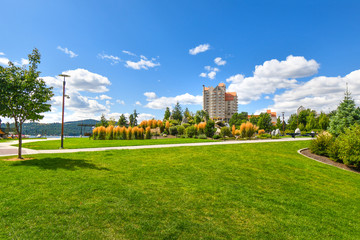 Fototapeta premium The lawn and manicured grounds of McEuen Park and the Coeur d'Alene Resort on Lake Coeur d'Alene in Northern Idaho, USA