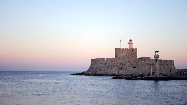 Timelapse on the sea and the entrance to the harbor in Rhodes greece