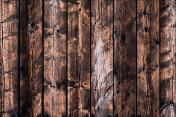 The texture of natural wood. Old empty brown rough boards. Abandoned boards for the background. Vertical layout.