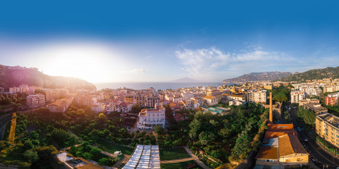 Beautiful panoramic aerial view on the center of Sorrento city, sunset, houses and streets, sea views and a Vizuvius, Napoli in the distance. Travel and vacation concept on Italy. Infrastructure.