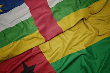 waving colorful flag of guinea bissau and national flag of central african republic.