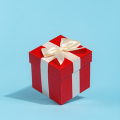 Red box for gifts on a blue background. Creative minimalistic concept. Valentine's Day
