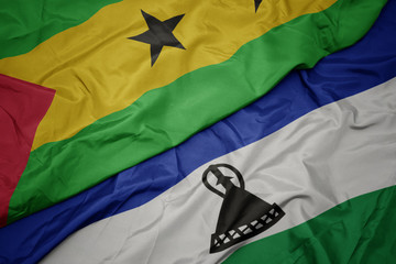 waving colorful flag of lesotho and national flag of sao tome and principe .