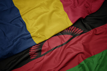 waving colorful flag of malawi and national flag of chad.