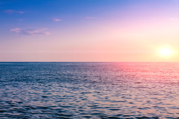 Naklejka na ściany i meble The sun sets in the sea. Use for background.
