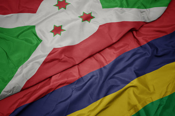 waving colorful flag of mauritius and national flag of burundi .