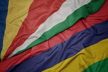 waving colorful flag of mauritius and national flag of seychelles.