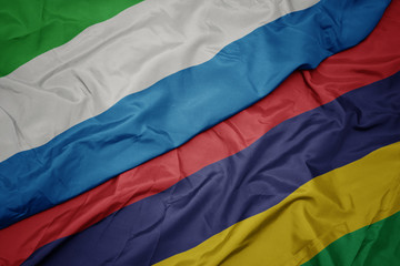 waving colorful flag of mauritius and national flag of sierra leone.