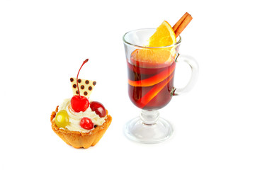 Delicious cupcakes with berries and glass with mulled wine isolated on a white background.