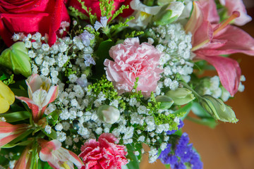 Red flower picture close up in the bouquet. The flower's petal . Bouquet of fresh red, white , orange roses . bouquet of multicolored roses .