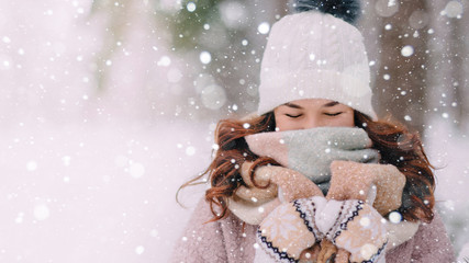 Close-up face of a woman closing a scarf from a snowfall