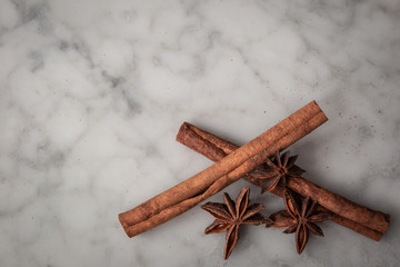 Cinnamon Sticks and Star Anise on a White Marble Table