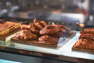 Tasty morning pastry for coffee on the display at traditional city cafe.