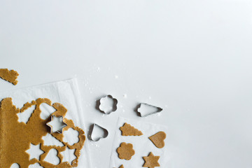 The process of making gingerbread cookies with rolling pin and sprinkled flour on a light gray background. Space for text