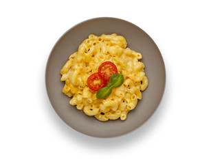 Isolated image of a bowl of delicious Macaroni and cheese, topped with cherry tomatoes and basil, in a grey bowl.