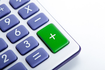 calculator with blue buttons with a green plus sign
