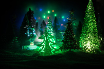 Empty space for your text. Christmas decorations. Fir tree standing on snow with beautiful holiday decorated background and traditional holiday attributes. Selective focus