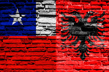 Flag of Chile and Albania on brick wall