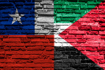 Flag of Chile and Palestine on brick wall