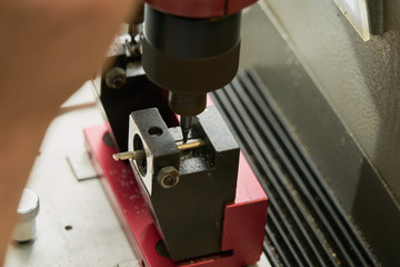 Key duplication machine operated by a locksmith in the process of duplicating a key
