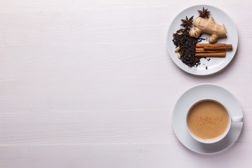 indian masala tea in a white cup on a white background with copy space, top view