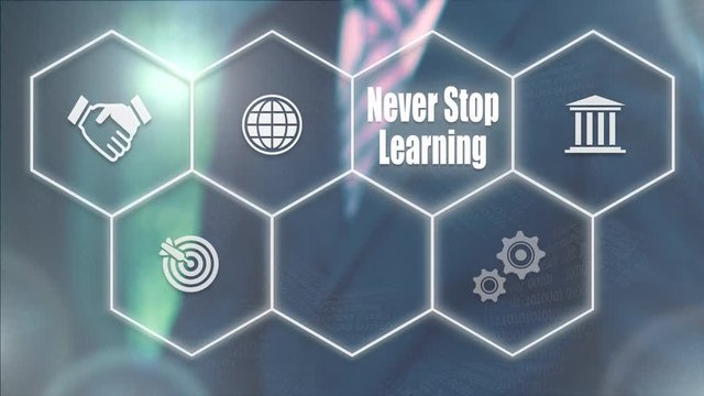 A businessman selecting a Never Stop Learning concept on a futuristic computer display with a blue background