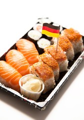 Sushi food on tray with German flag against white background