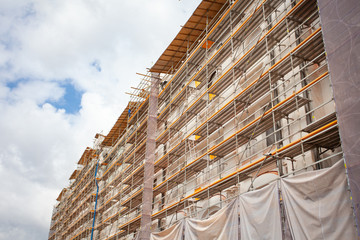 Obraz premium Construction Scaffoldings. Reconstruction of an architectural monument. Historical place.Concrete building.