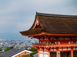 Main Gate of Kiyomizu-dera Temple with brown roof and red wooden base in Kyoto, Japan