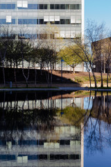Fototapeta na wymiar Abstract Architecture Background. Water Reflections of Modern Office Building.