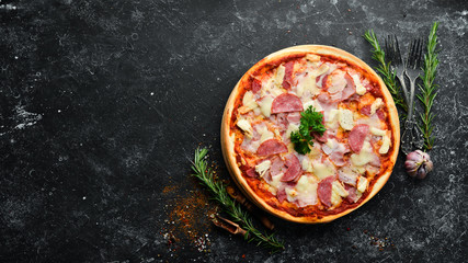 Homemade pizza with bacon, chicken and salami sausage. Top view. free space for your text. Rustic...