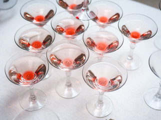 Luxury Banquet table with a pyramid of champagne glasses with cherries.