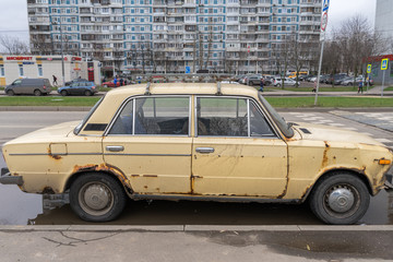 old rotten rusty russian car in the city