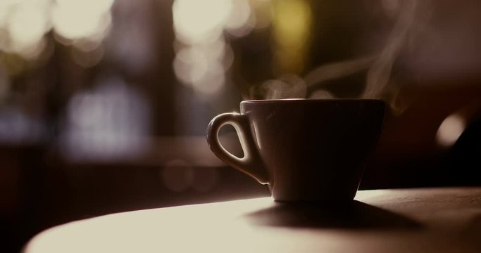 Close up 4K shot of a hot coffee cup with steam coming out of it, in a morning, in Bucharest, Romania.