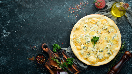 Four cheese pizza. Blue cheese, mozzarella, brie. Top view. free space for your text. Rustic style.