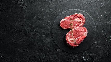 Raw marbled meat Steak Ribeye Black Angus. Top view. free space for your text. Rustic style.