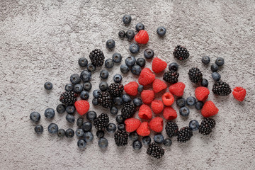 Mixed sweet berries on stone board