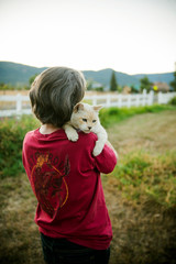 Person holding cat on a farm