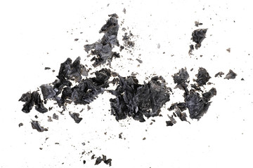 Pieces of burnt paper on a white background. The ashes of the paper. Charred paper scraps.
